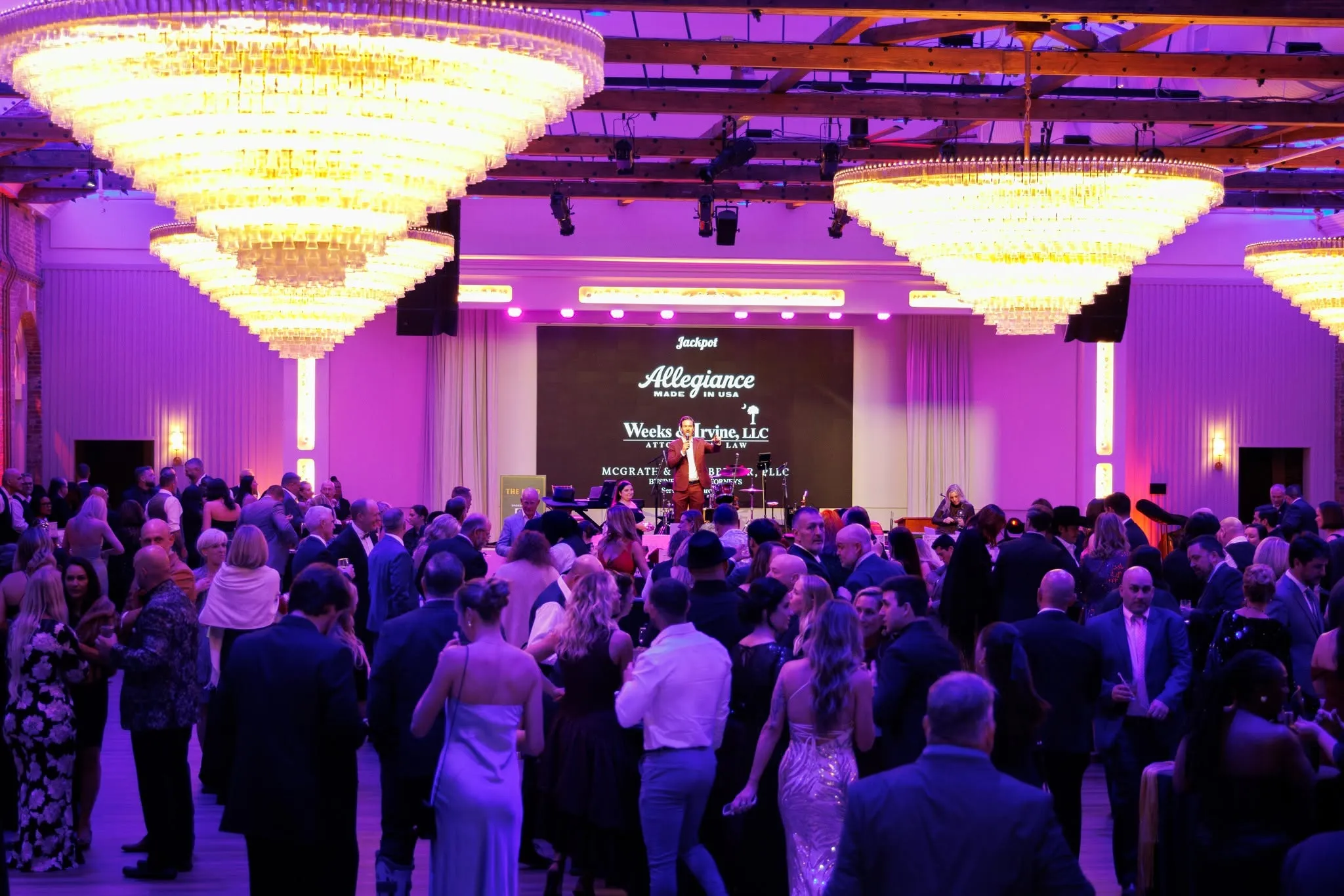 The ballroom full of guests under the chandeliers